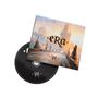 Text: "Era", "VII". Albumcover mit Stadtlandschaft, Sonnenuntergang und gotischer Architektur. Eine CD ragt heraus.
