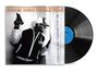 "BOOGIE DOWN PRODUCTIONS" und "BY ALL MEANS NECESSARY" auf einem Albumcover mit einer Person, die eine Waffe hält.