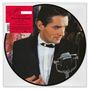"Rock Me Amadeus, 40th Anniversary No.1 Edition, Limited Picture Disc. Ein Mann im Anzug mit Mikrofon."
