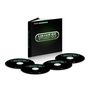 "Now Yearbook Vault '85", ein schwarzes Buch mit vier dazugehörigen CDs, die als "CD One" bis "CD Four" beschriftet sind.