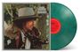 Text: "Bob Dylan Desire". Das Cover zeigt eine Person mit Hut und Fellmantel; daneben eine grüne Vinyl-Schallplatte.