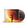 "traces live". Silhouette eines springenden Mannes vor großem, leuchtendem Sonnenuntergangshintergrund. CD-Hülle und Disc.