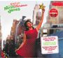 „I Dream of Christmas, Norah Jones“, ein Cover mit rotem Kleid, Frau hebt Stern in Stadtansicht.