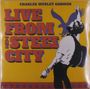Text: "CHARLES WESLEY GODWIN. LIVE FROM THE STEEL CITY." Illustration: Mann mit Gitarre, Adler im Hintergrund, gelber Hintergrund.