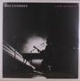 Text: "GAZ COOMBES", "LIVE IN PARIS". Silhouette eines Musikers mit Gitarre und Mikrofon vor hellem Licht.