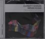 Text: "Christy Doran, Imran Khan, Disambiguation." Buntes, abstraktes Band auf dunklem Hintergrund.