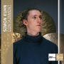 Text: "SIMON KUHN CONTAINMENT" und "Jazz thing NEXT GENERATION VOL. 114". Ein Mann im Rollkragenpullover vor Gongs.