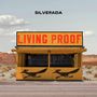 Text: "SILVERADA", "LIVING PROOF". Gelbes Gebäude mit Vogel-Silhouetten, Wüstenlandschaft im Hintergrund.