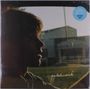 Text: "patchwork", "SEA BLUE VINYL". Ein Silhouettenprofil einer Person vor einem Gebäude im Hintergrund.