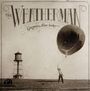 "The Weatherman, Gregory Alan Isakov" steht oben. Eine Person hält einen großen Ballon, im Hintergrund ein Wasserturm.