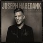 Text: "Joseph Habedank, The Worship Album". Ein Mann in Lederjacke schaut lächelnd zur Seite. Sepia-Ton.