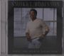 Text: "SMOKEY ROBINSON" oben, "WHAT THE WORLD NEEDS NOW" unten. Ein Mann in weißem Pullover lehnt sich lächelnd an.