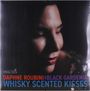 "Daphne Roubini and Black Gardenia Whisky Scented Kisses." Bild einer Frau mit geschlossenen Augen und roten Lippen.