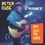 "Peter Case at McCabe’s", "My Life to Live". Eine Person spielt Gitarre auf einer Bühne mit Mikrofon, trägt Hut und Jacke.