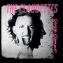 Texte: "THE CLAUDETTES", "Garage Glamour". Ein Gesicht mit aufgerissenem Mund und explosiver Frisur im Stil von Surrealismus.