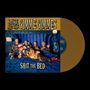 „SPIKE AND THE GIMME GIMMES, SHIT THE BED“. Fünf Personen in Leopardenanzügen liegen auf einem blauen Bett.
