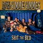 "SPIKE AND THE GIMME GIMMES" und "SHIT THE BED". Fünf Personen in Leoparden-Pyjamas auf einem blauen Bett.