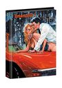 „Emanuelle 5“ in roter Schrift. Eine Illustration zeigt eine Frau auf einem roten Auto, umarmt von einem Mann in weißem Hemd.
