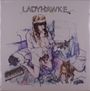 "LADYHAWKE" steht über einer Frau mit Stirnband, die kniet und ein Videospiel spielt, umgeben von Katzen.