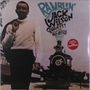"Ramblin' The Jack Wilson Quartet featuring Roy Ayers." Ein Mann vor einer alten Lokomotive, trägt Pullover und Jacke.