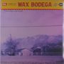 Oben steht "WAX BODEGA", daneben "These Days are Gone." Darunter eine Landschaft mit Bergen und Häusern.