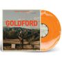 Titel "GOLDFORD" oben "ORANGE BLOSSOMS". Ein Mann mit Gitarre in wüstenartiger Landschaft. Orangefarbene Vinyl-Schallplatte.