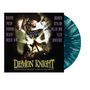 "Demon Knight" steht groß unten, darüber ein Skelett mit Hut, offene Hände haltend ein beleuchtetes Buch mit der Aufschrift "Tales from the Crypt". Oben links und rechts sind Bandnamen aufgelistet.