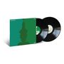 Text: "Meshell Ndegeocello," "Ventriloquism." Cover mit grünem Profil, zwei schwarze Vinyl-Schallplatten im Hintergrund.