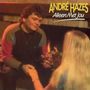 "ANDRÉ HAZES Alleen Met Jou" steht oben. Ein Mann und eine blonde Frau halten Hände und trinken Wein vor einem Kamin.