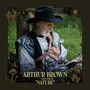 "Arthur Brown with Dan Smith 'Nature'." Ein älterer Mann in mittelalterlichem Kostüm mit Hut sitzt draußen und liest.