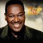 Text: "Luther Vandross, Hidden Gems". Ein lächelnder Mann in einem dunklen Anzug vor einem verschwommenen Hintergrund.