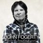 "JOHN FOGERTY - Wrote A Song For Everyone". Ein Mann in kariertem Hemd, Bandana um den Hals, schaut freundlich.