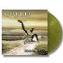 "CREED" und "human clay". Ein Mensch aus Erde erhebt sich auf einem Weg in einer surrealen Landschaft.