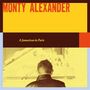 "MONTY ALEXANDER" und "A Jamaican in Paris" sind in warmen Farben zu lesen. Rückansicht eines Mannes vor einem Klavier.