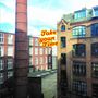 Text: „Take your Time” und „the berlin tapes”. Stadtbild mit Backsteingebäuden und Schornstein bei klarem Himmel.