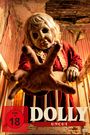 Text: "MAMA WEISS ES AM BESTEN", "DOLLY", "BALD IM KINO". Eine gruselige Puppe in einem spärlich beleuchteten Raum.
