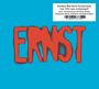 "German New Wave-Kultalbum von 1982 neu aufgelegt!" in Schwarz auf Weiß. Großes rotes Wort "ERNST" auf blauem Hintergrund.