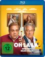 Texte: "OH LA LA 2", "NEUE TESTS, NEUES CHAOS", "ANALYSIS". Zwei Männer und zwei Gemälde an einer gelben Wand.