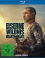 Text: "Eiserne Wildnis: Heart of the Beast", "FSK ab 12 freigegeben", "Vorab-Cover". Mann mit Bart in Tarnkleidung mit Hund.