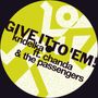 Text: "GIVE IT TO 'EM! kridelka ft. chanda & the passengers." Gelber Hintergrund mit abstrakten weißen Formen.