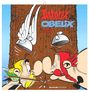 "Asterix & Obelix 2024" steht oben. Zwei Comic-Figuren mit Helmen stehen Nase an Nase vor einem Baumstamm.
