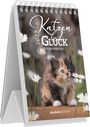 Text: "Katzen Glück 2024 Wochenkalender." Ein flauschiges Kätzchen sitzt zwischen weißen Gänseblümchen auf einem Tisch.