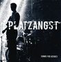 Text: "PLATZANGST" und "SONGS FOR HEROES". Silhouette eines Musikers mit Gitarre auf der Bühne.