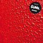 Schwarze Kreisform mit „TOPSY TURVY RECORDS GUNK SKUNK“. Texturierte, leuchtend rote Fläche im Hintergrund.