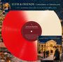 "ELVIS & FRIENDS Christmas at Graceland" steht auf einem zweifarbigen Vinyl. Weihnachtsdekor und ein Haus im Hintergrund.