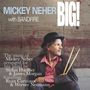 Text: "Mickey Neher BIG! with BANDFIRE. The music of Mickey Neher arranged for big band by Stefan Huefner & James Morgan featuring Ryan Carniaux & Werner Neumann." 

Ein Mann in elegantem Outfit mit Schlagzeugstöcken in der Hand sitzt seitlich.