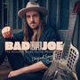 Texte: "BAD TEMPER JOE", "The Acoustic Blues Guitar Revue Vol 1", "Original Songs of Bad Temper Joe". Mann mit Hut neben Gitarre.