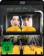 Text oben: "You are the film". Darunter zwei Gesichter hinter gelben Kinositzen. Text unten: "Vom Schöpfer von BEYOND THE INFINITE TWO MINUTES und RIVER". FSK 12 Logo.