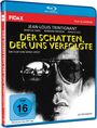 Text: "Der Schatten, der uns verfolgte", "Jean-Louis Trintignant", "FSK ab 16". Illustration eines Mannes mit Sonnenbrille.