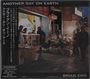 „ANOTHER DAY ON EARTH“, „BRIAN ENO“. Asiatischer Markt mit Menschen, Gemüse und beleuchteten Ständen.